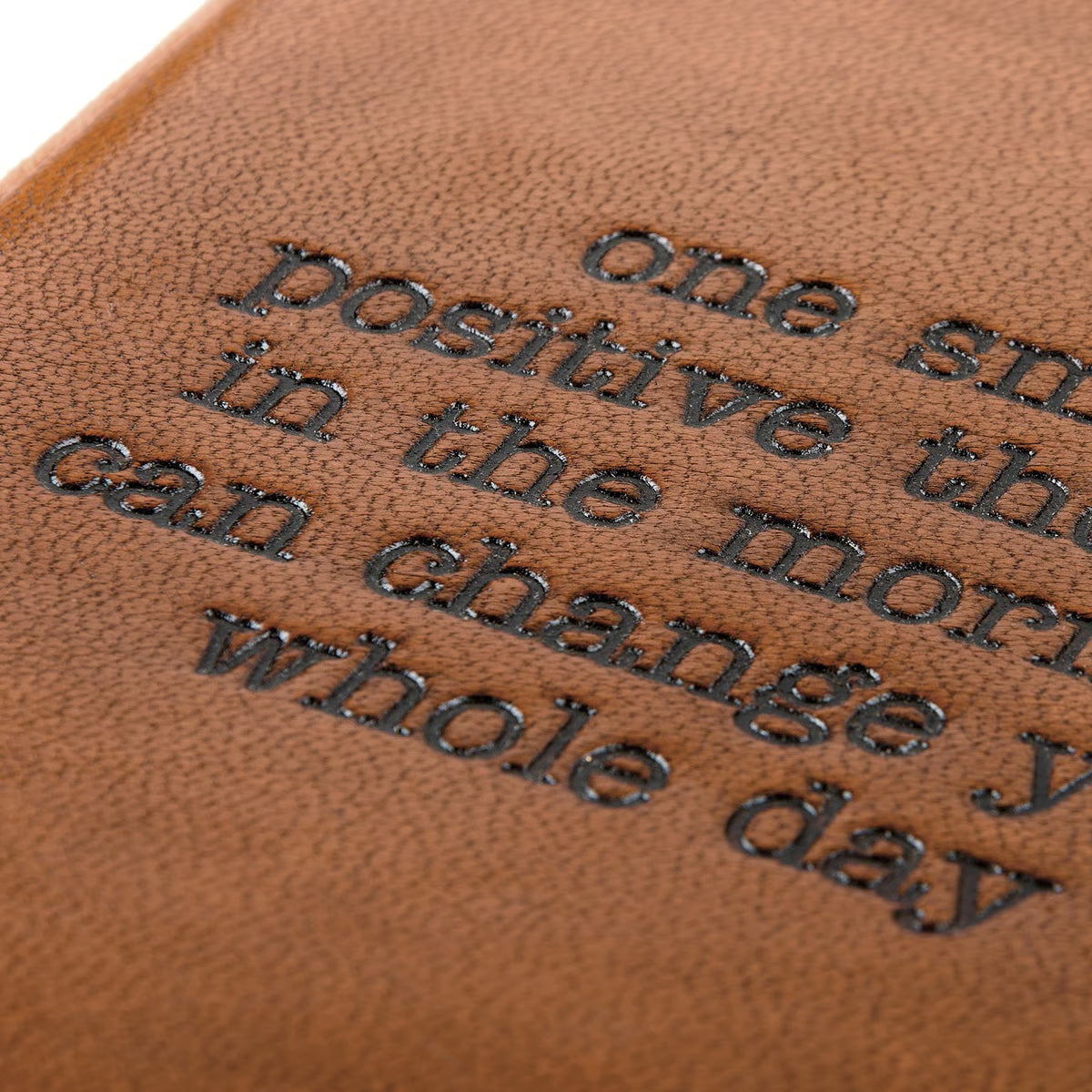 Brown leather surface with embossed text