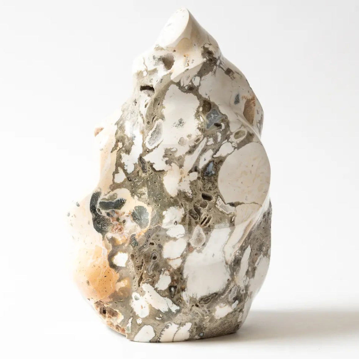 Decorative ocean jasper stone with a textured surface on a white background