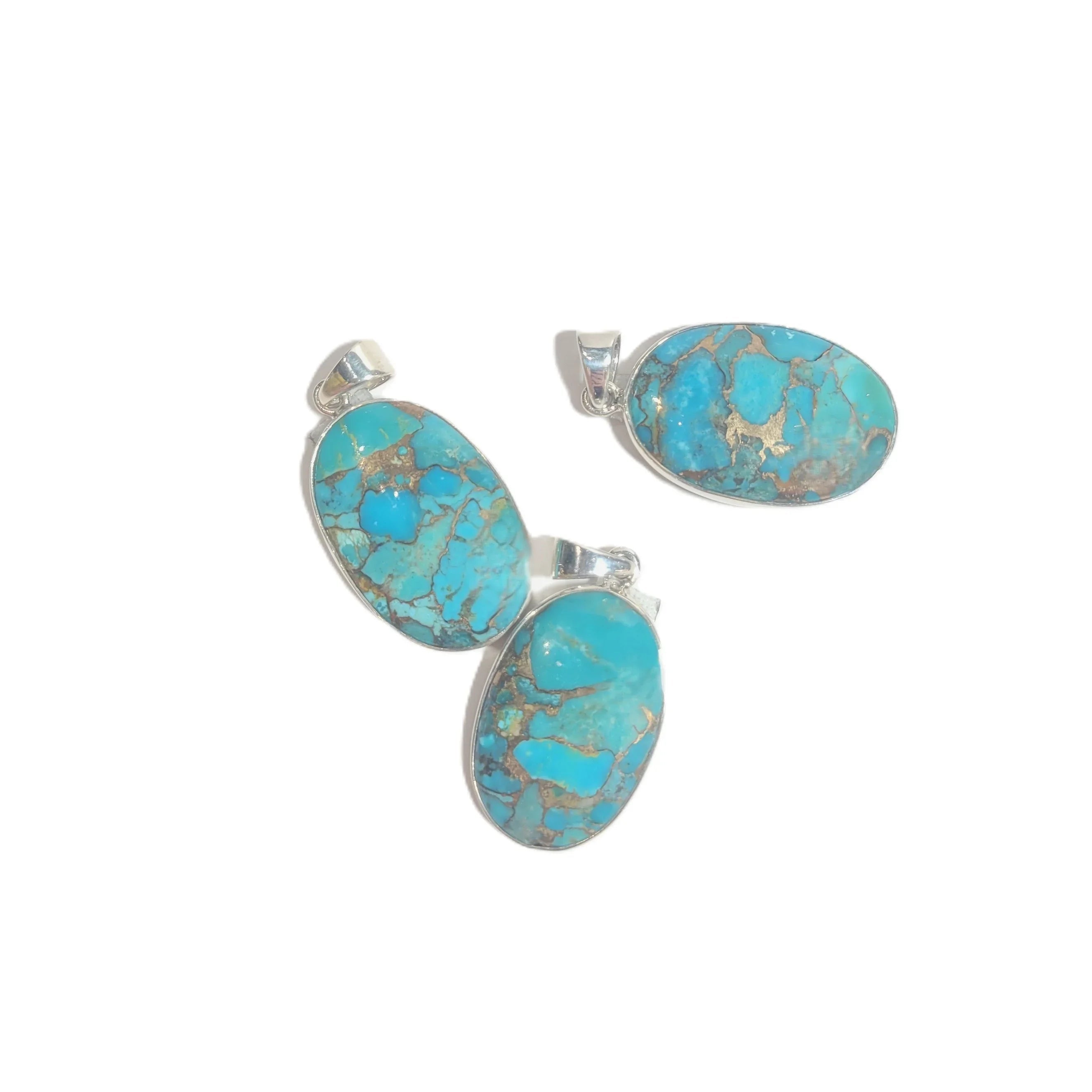 Turquoise stone pendants with silver settings on a white background