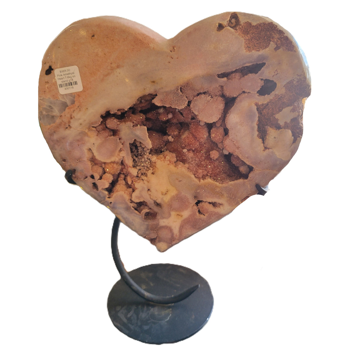 Heart-shaped stone on a stand with a white background