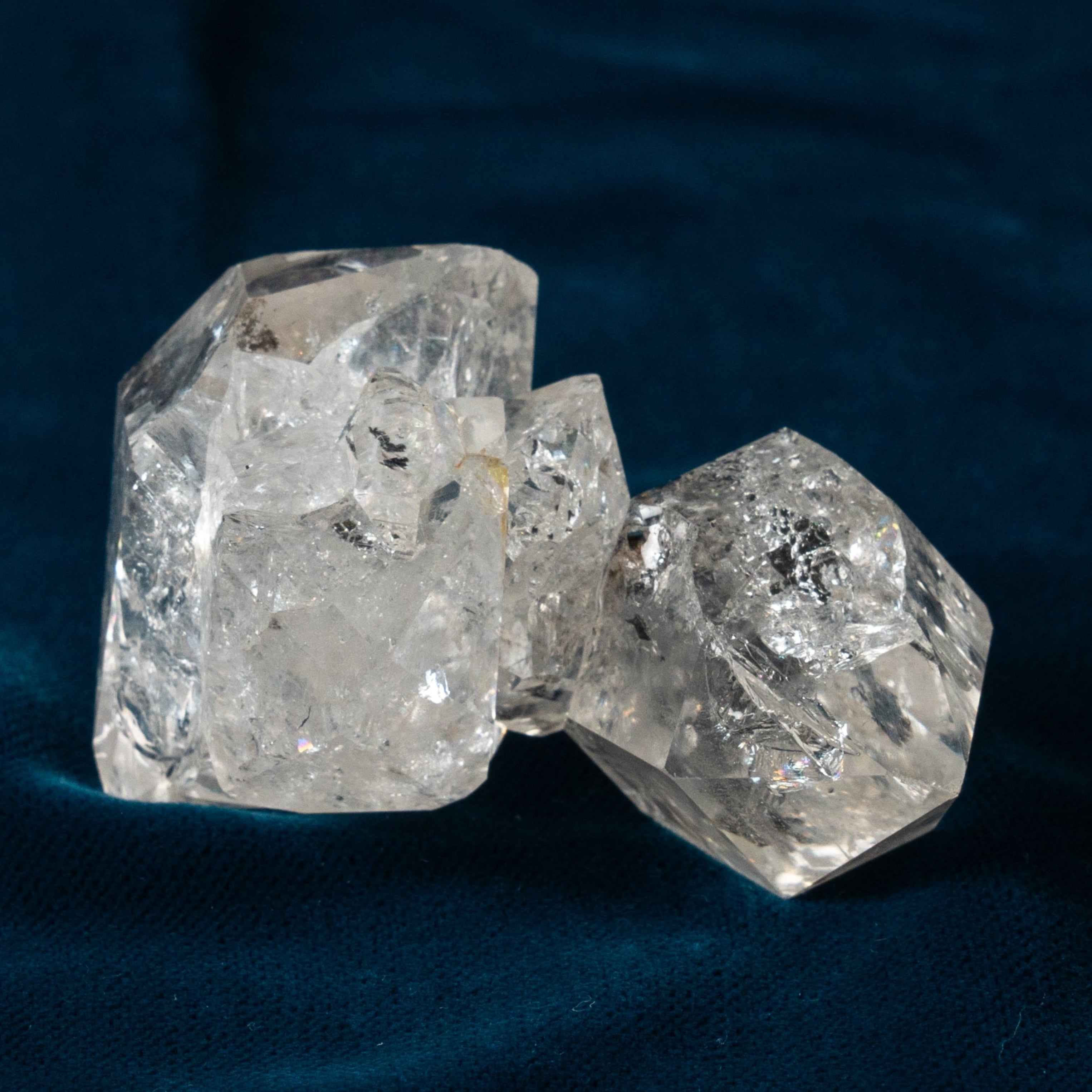 double herkimer diamond cluster on a dark blue fabric background