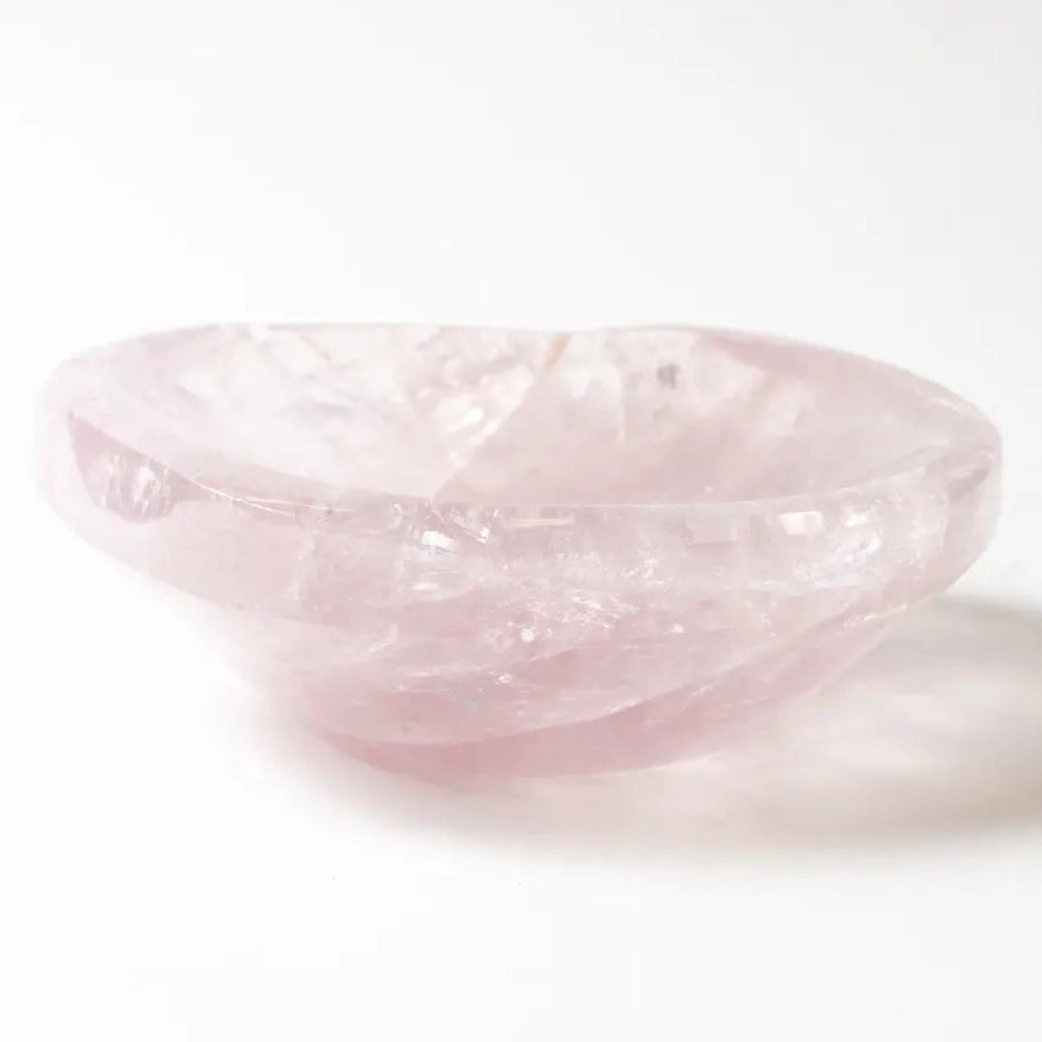 Pink rose quartz bowl on a white background