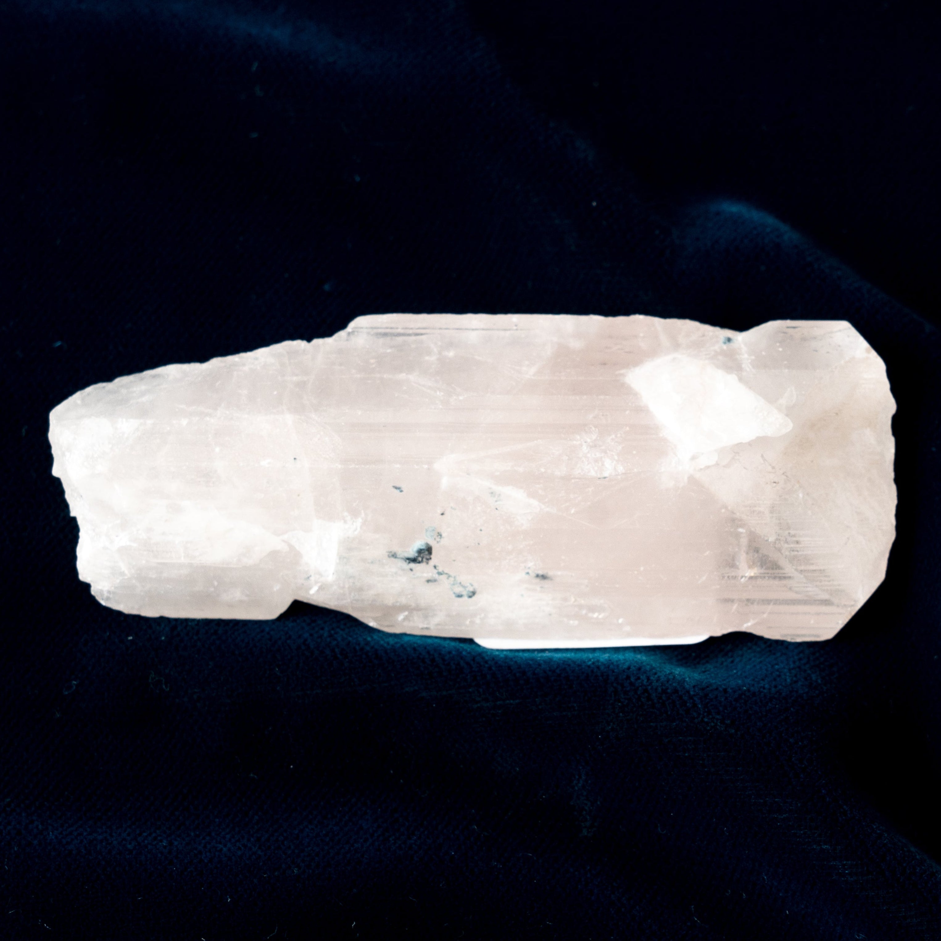 Clear Danburite crystal rock on a dark background