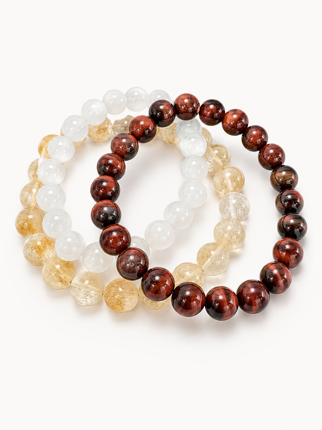 Three beaded bracelets in white, brown, and beige on a white background