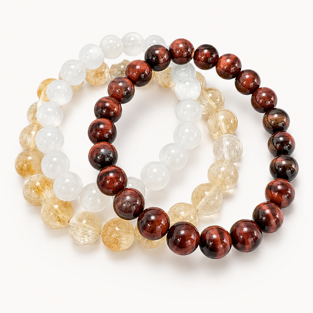 Three beaded bracelets in white, brown, and beige on a white background