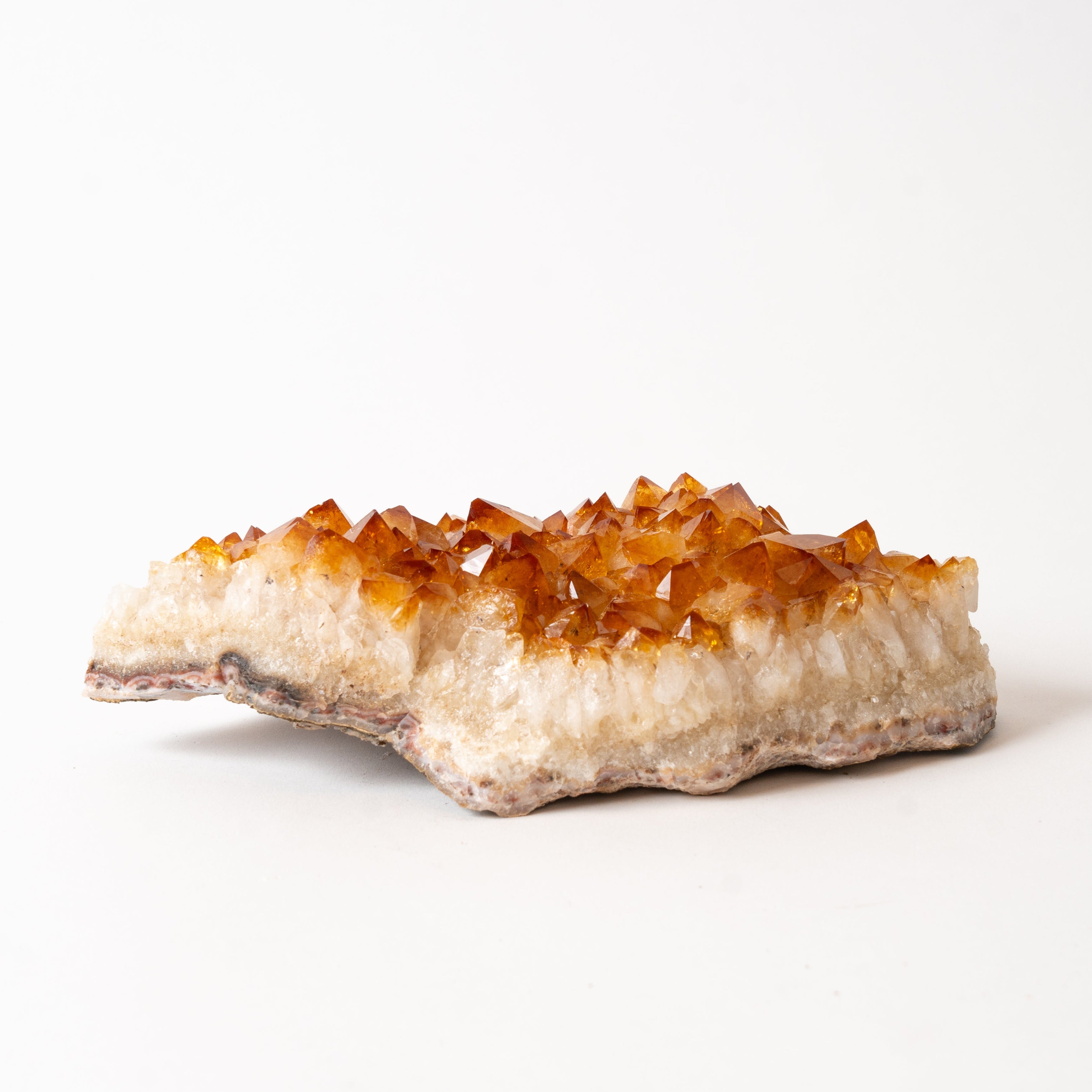 Crystal rock with orange crystals on a white background