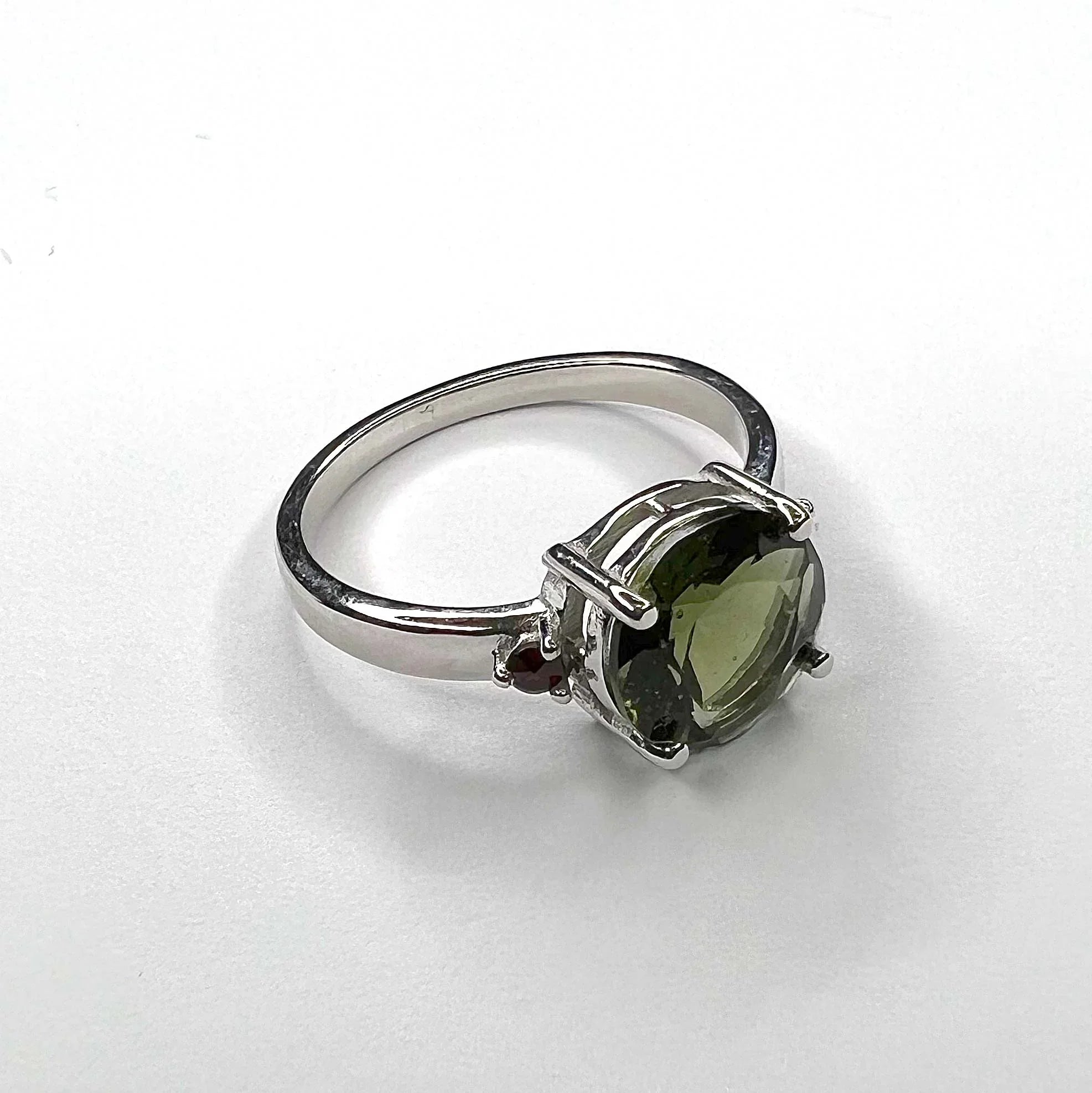 Moldavite Faceted Oval Ring with Garnet Accents