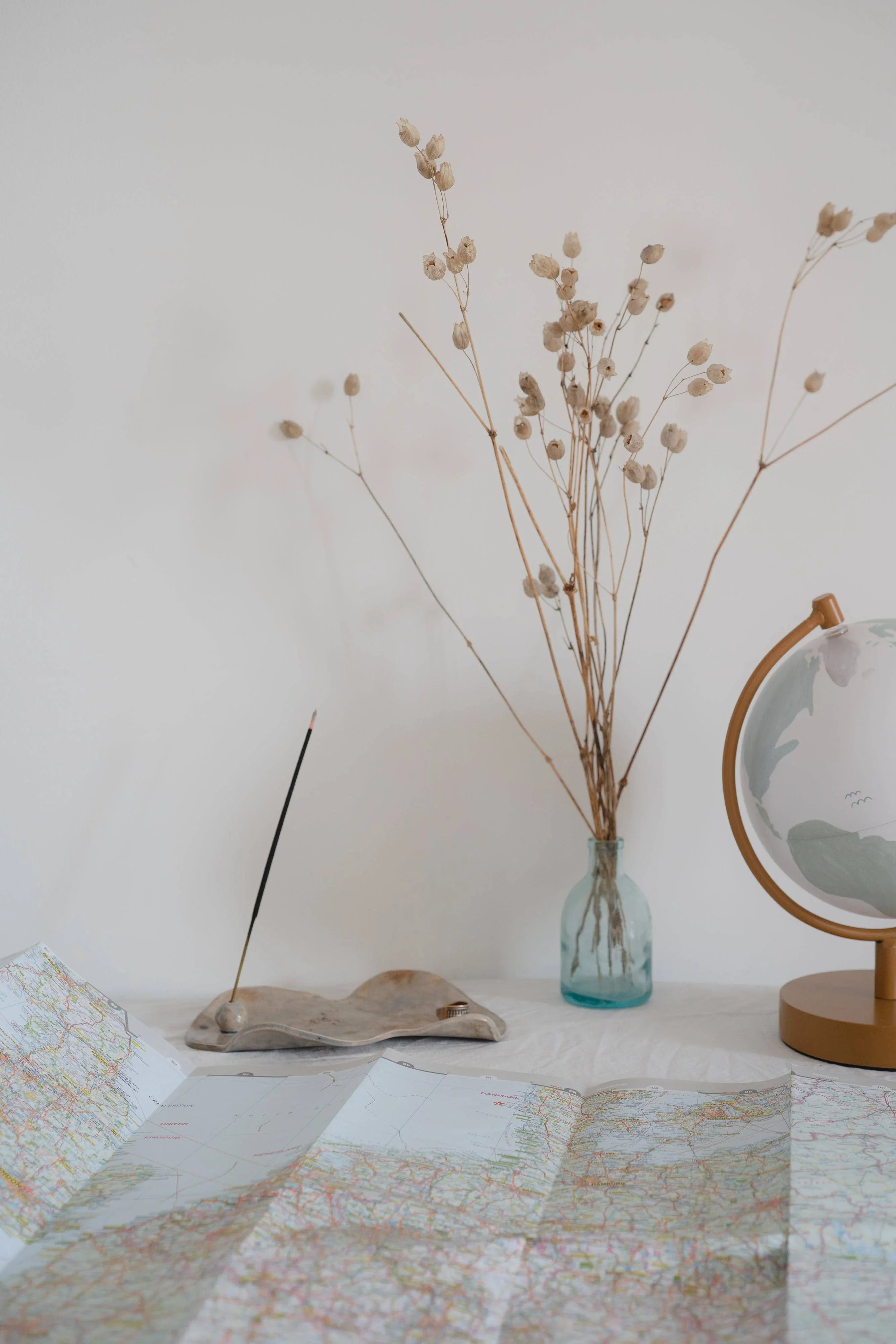 manifestation Incense on Table with Map and Globe