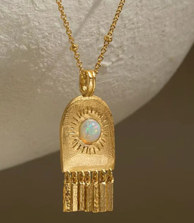 Open Door Solar Chime Amulet Necklace on Brown Background