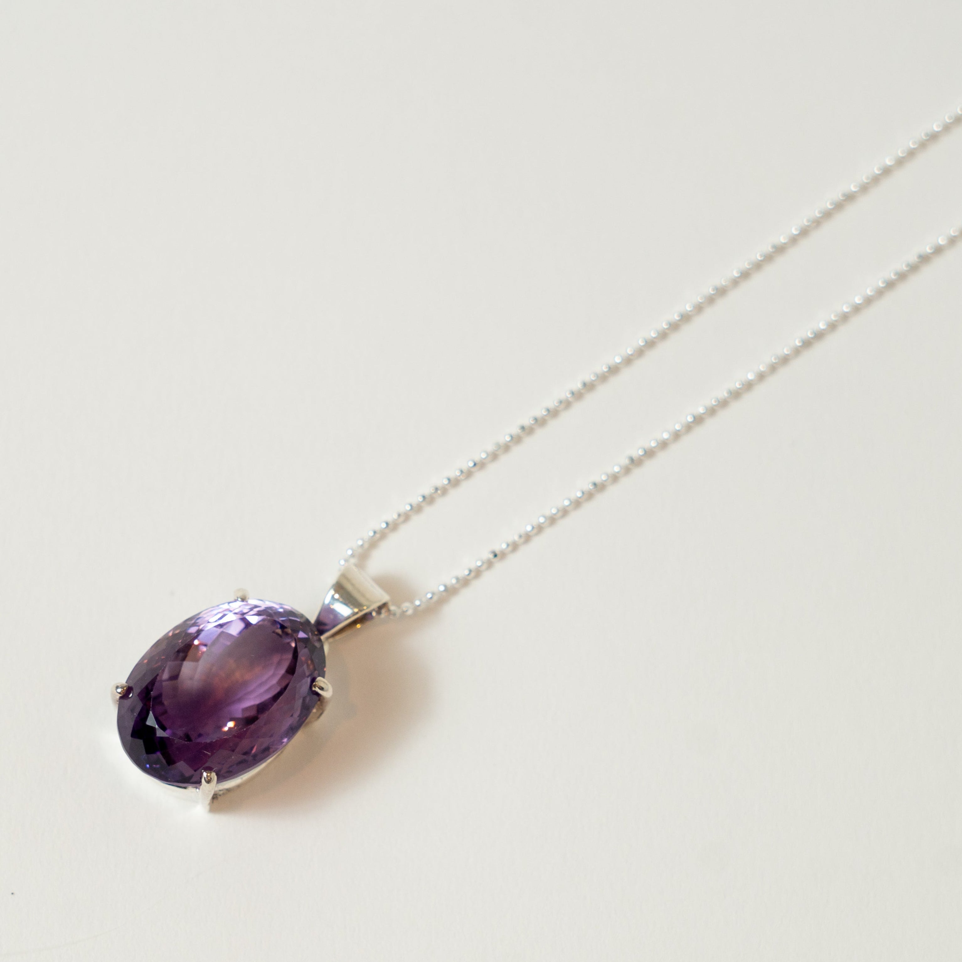 Purple Amethyst gemstone necklace on a white background