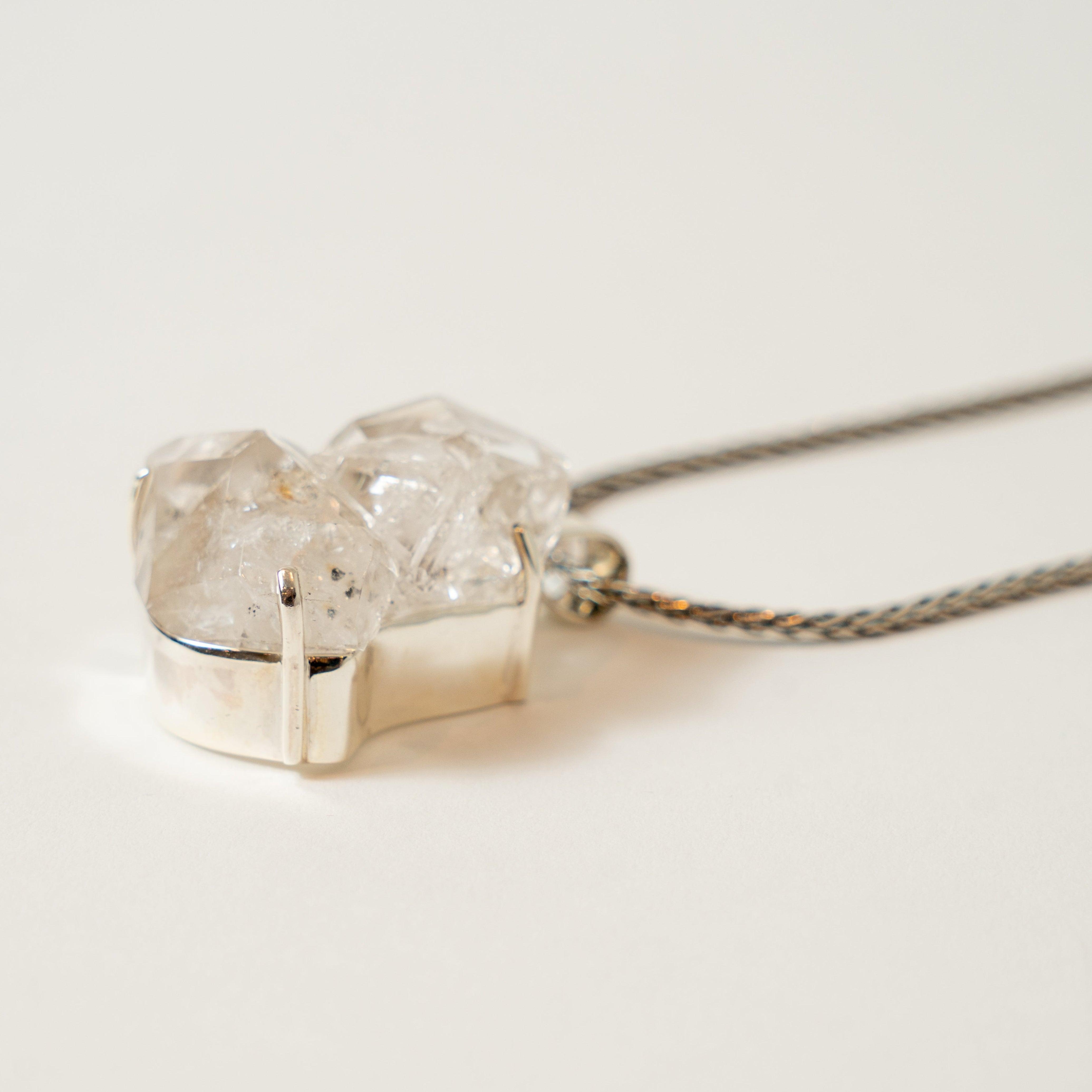 Silver necklace with a unique Herkimer Diamond Stone pendant on a light background