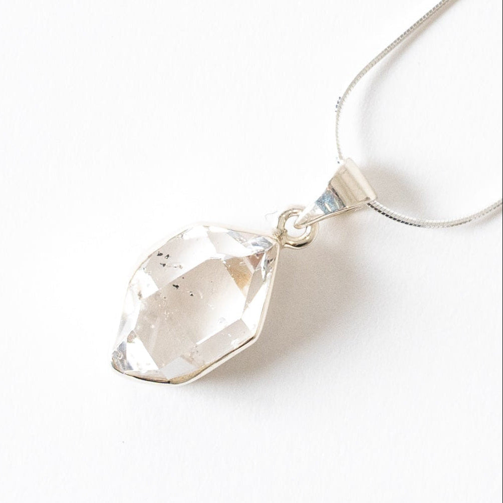 Herkimer Diamond Crystal pendant necklace on a white background