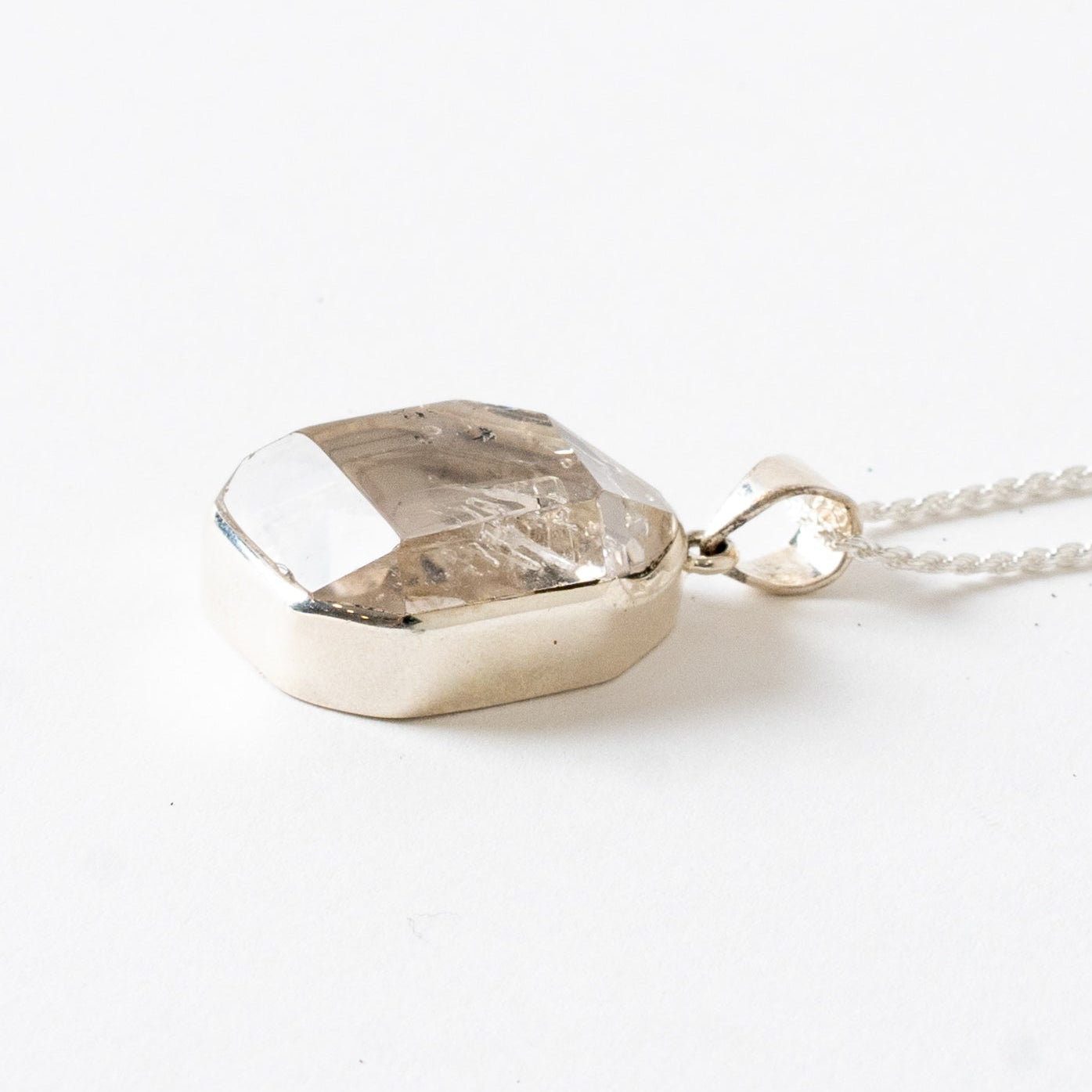 Herkimer Diamond pendant necklace on a white background Side View