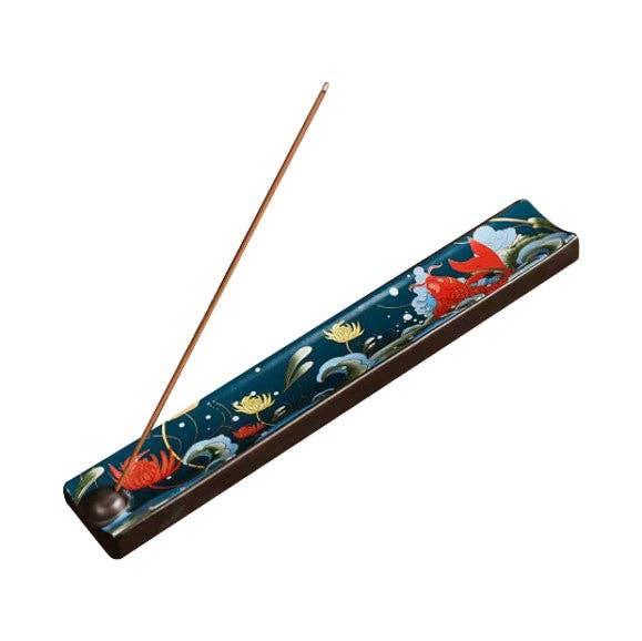 Koi Fish Incense stick holder with floral design on a white background