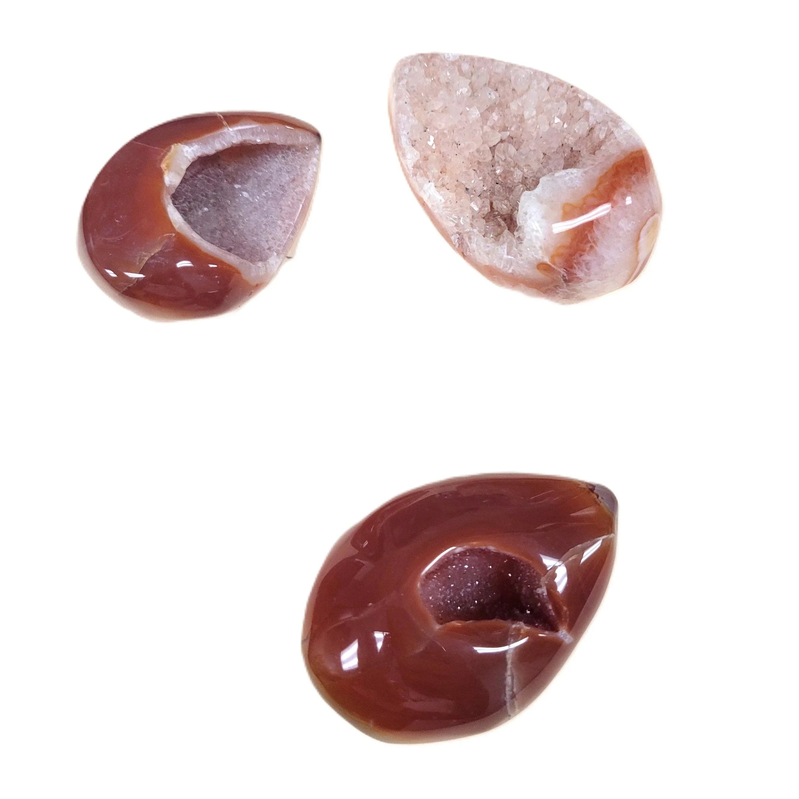 Three teardrop-shaped Carnelian agate stones on a white background