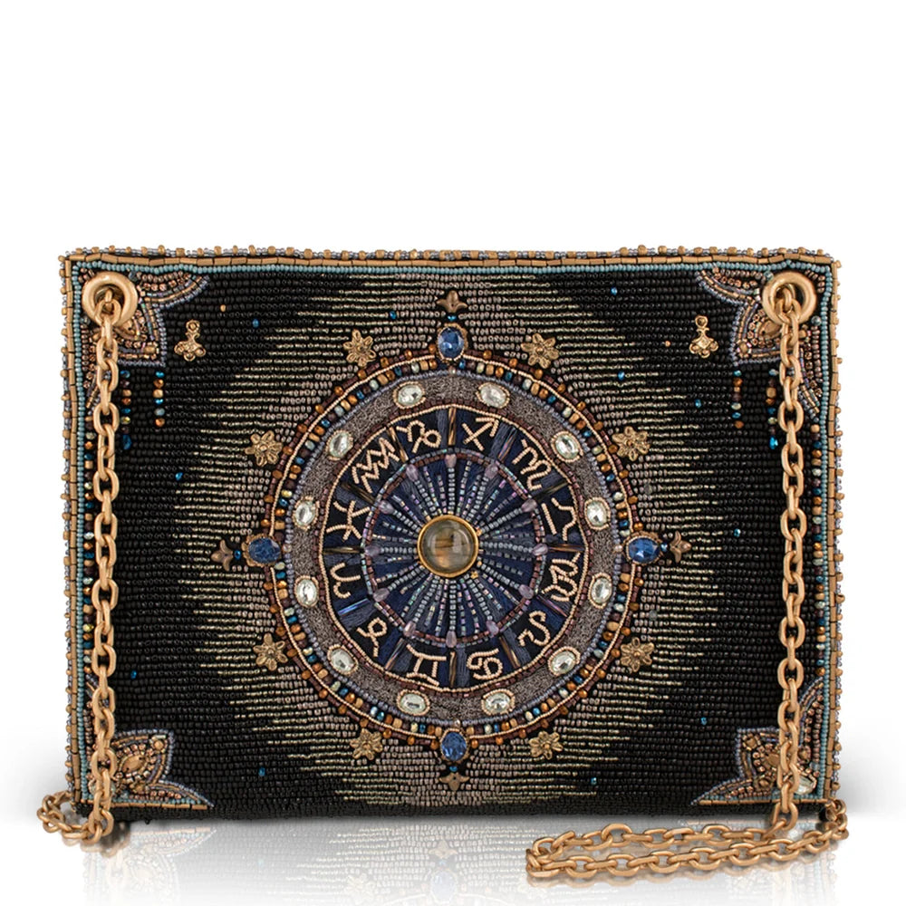 Decorative clutch bag with zodiac design on a white background