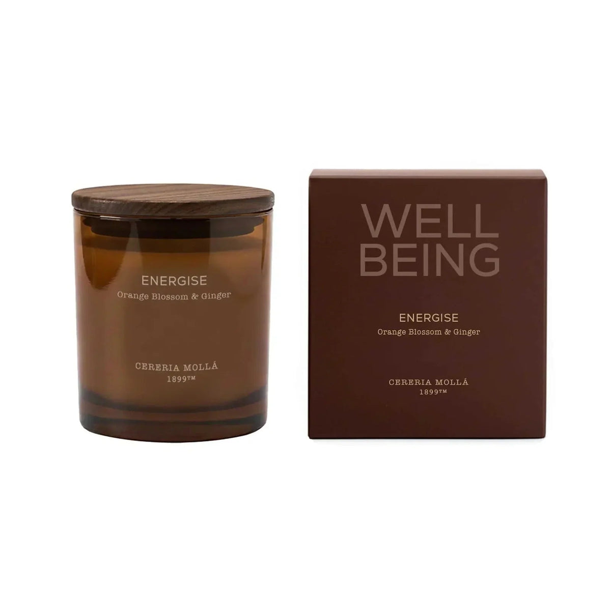 An amber glass jar candle with a dark wooden lid sits next to its matching brown packaging box on a plain white background. The box features the text 'WELL BEING' and 'ENERGISE' with the brand 'CEREBIA MOLLA 1897'.
