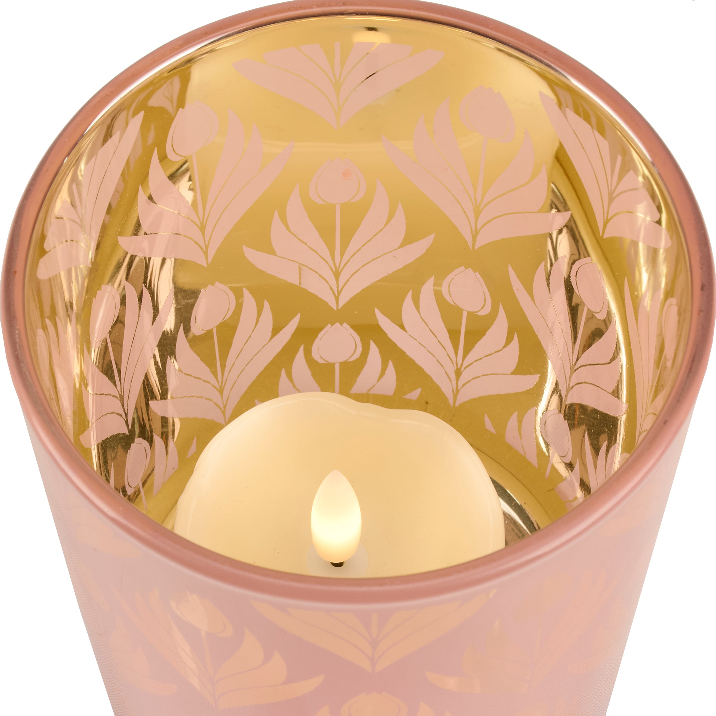 Decorative candle in a pink holder with floral patterns on a white background