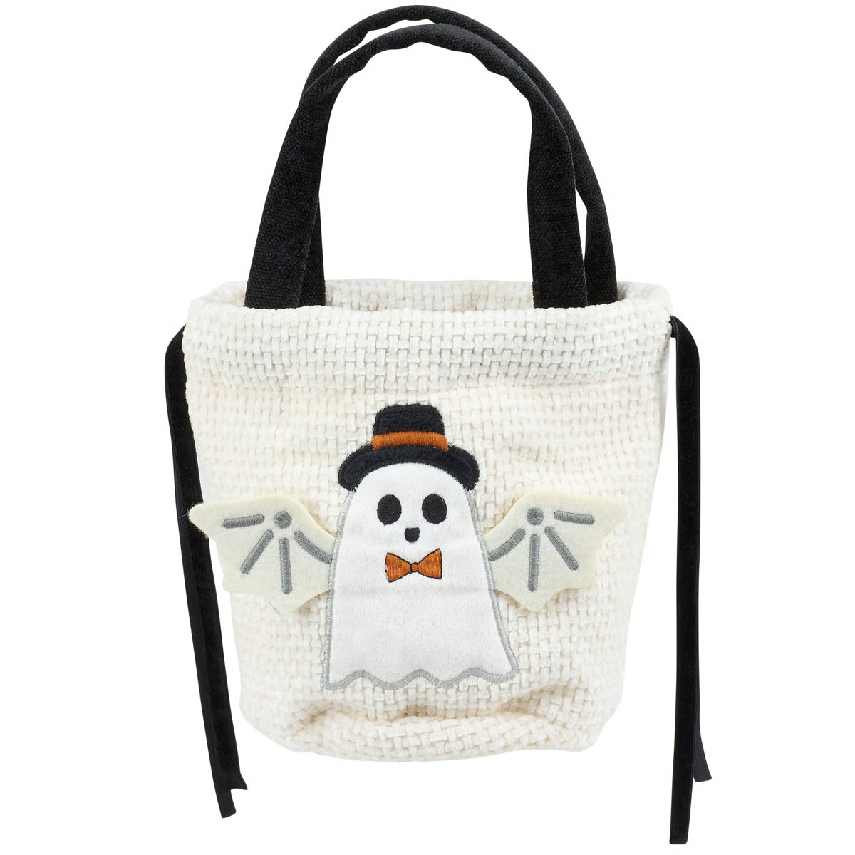 An off-white textured fabric tote bag with black handles and side ties, featuring a cute ghost applique wearing a black top hat and orange bow tie on the front.