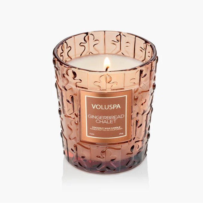 Gingerbread ChaletDecorative candle in a rose gold holder with 'Voluspa' branding on a white background