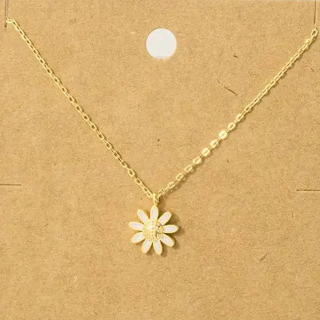 Gold necklace with a flower pendant on a brown card with text