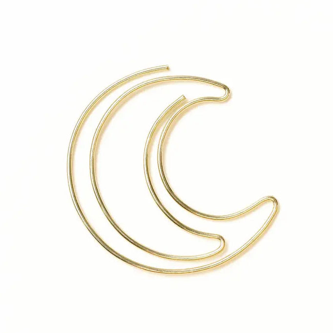 Gold crescent moon-shaped book mark on a white background