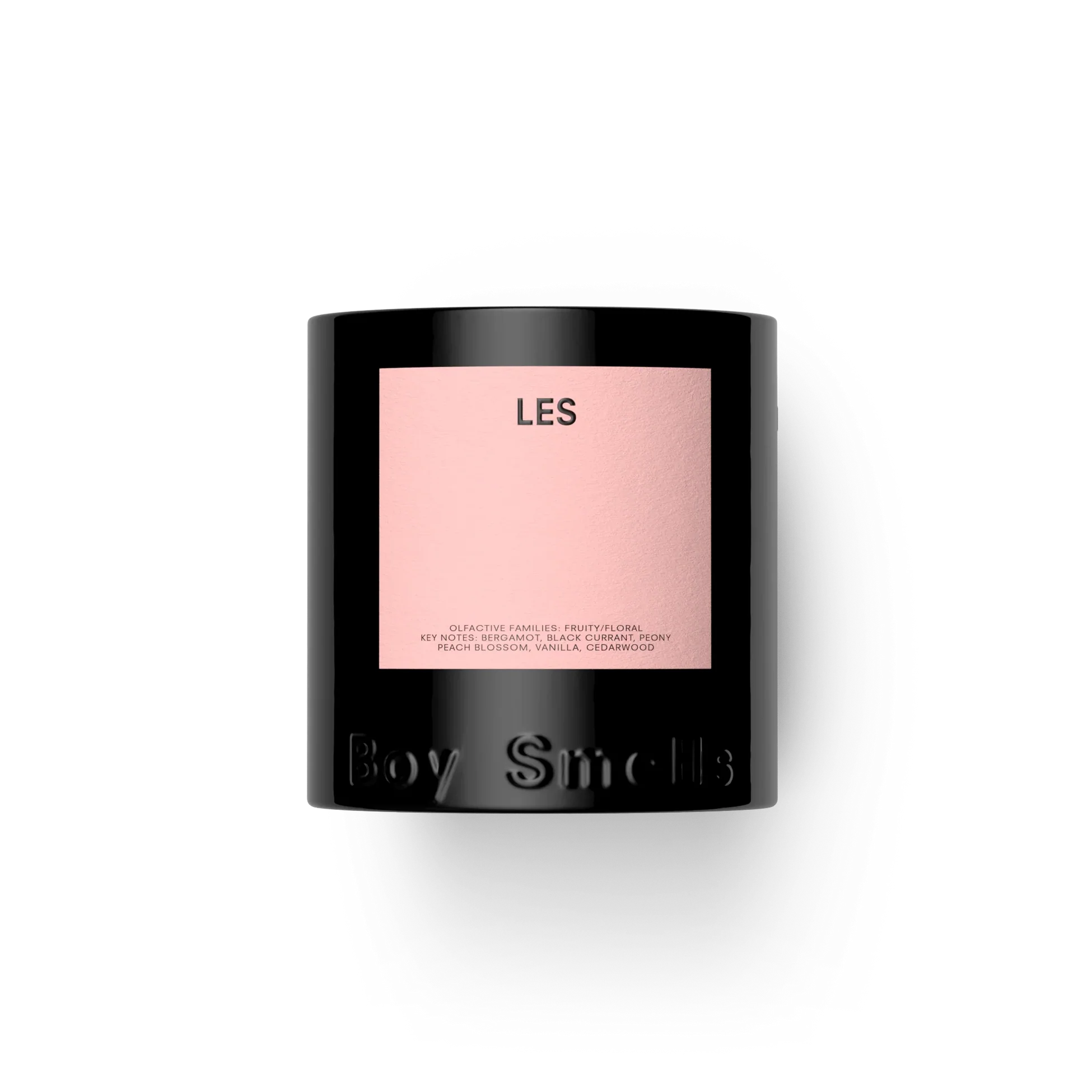 Les Black candle with a pink label on a white background