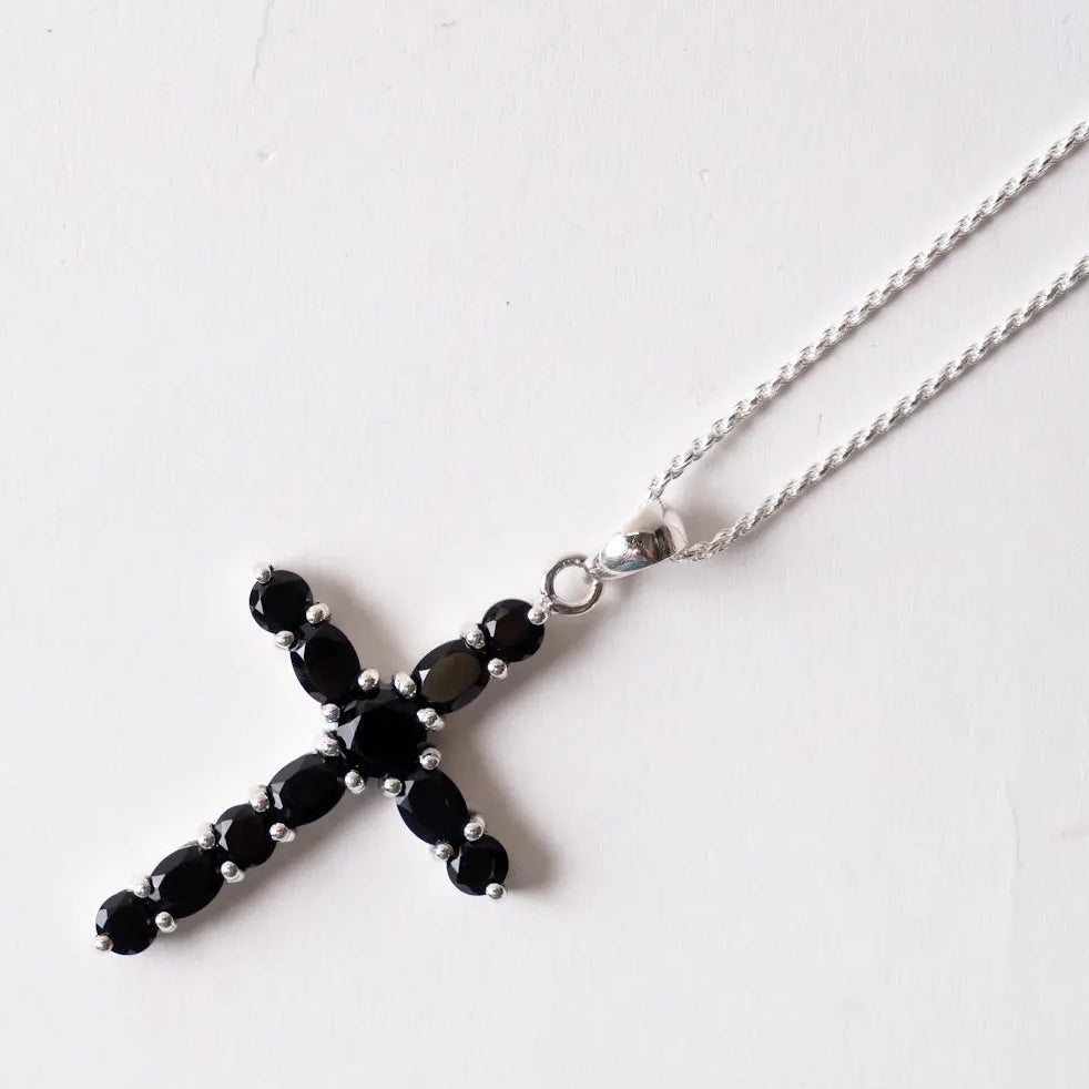 Necklace with a black onyx cross pendant on a white background