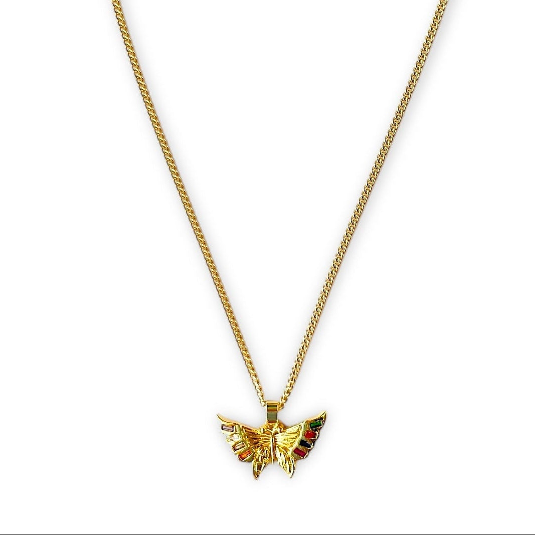 Gold butterfly pendant necklace on a white background