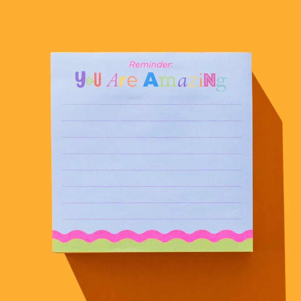 Notepad with 'You Are Amazing' text on a bright orange background