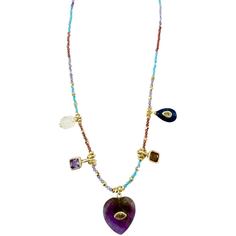A bohemian-style beaded necklace with a large purple amethyst heart pendant, gold-tone chain and settings, and multiple colorful gemstone charms including blue, purple, white, and brown on a plain white background.