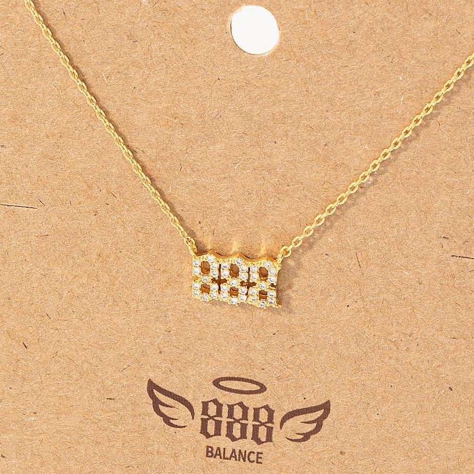 Gold necklace on a brown card with '888 Balance' branding