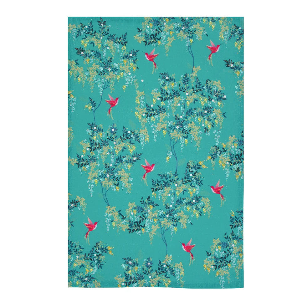 A tea towel featuring a repeating pattern of teal, green, and yellow foliage with small pink birds on a turquoise background.
