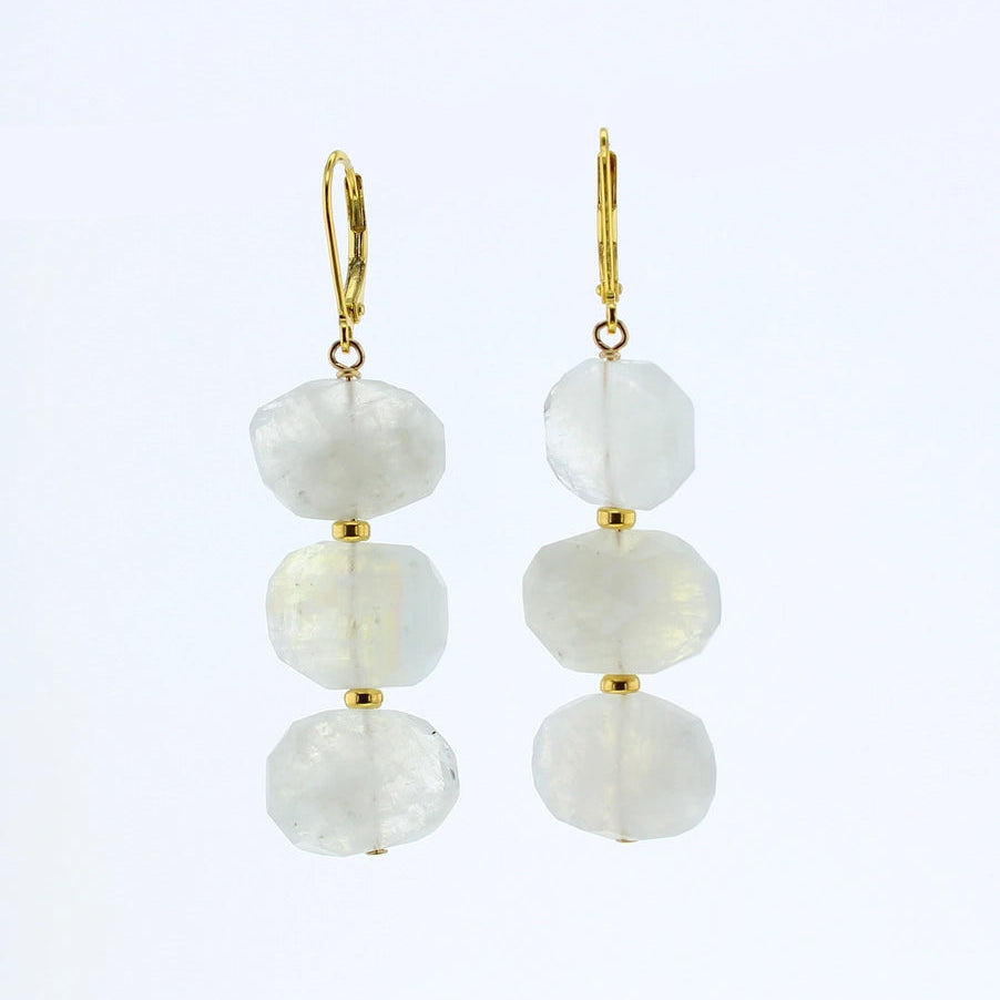 A pair of gold leverback drop earrings featuring three faceted, irregular white gemstone beads stacked vertically on each earring, shown against a plain white background.