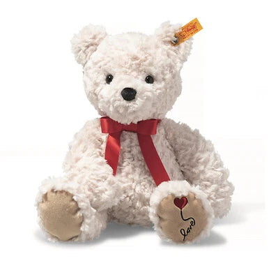 Steiff White teddy bear with a red bow and heart detail on a white background