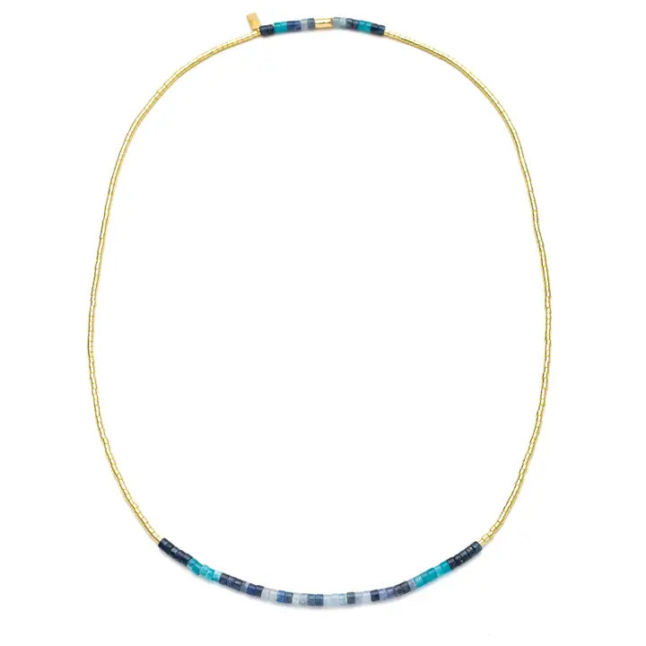 A delicate gold beaded necklace with a central horizontal row of small blue, turquoise, and white beads, displayed on a clean white background.