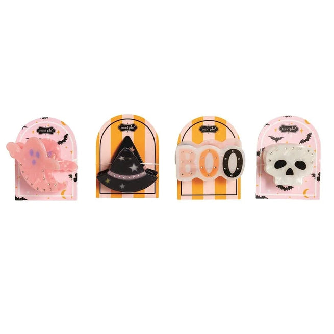 Four Halloween-themed plastic accessories in blister packaging, including a pink bat, a black witch hat, orange and white 'BOO' letters, and a white skull.