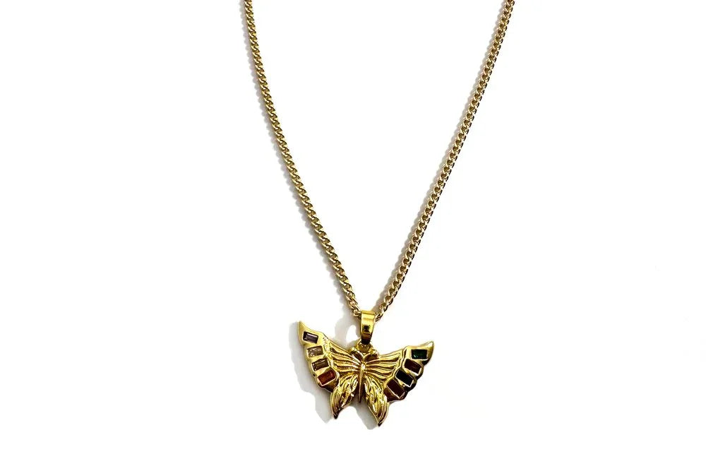 Gold butterfly pendant necklace on a white background