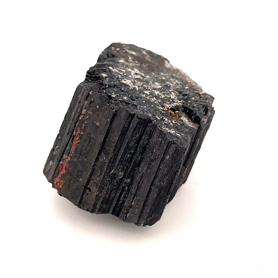 Black mineral tourmaline crystal on a white background