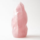 A polished pink rose quartz crystal tower with a natural organic shape, standing upright on a white surface against a white background.