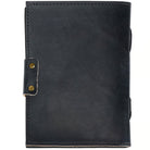 Black leather notebook with gold rivets on a white background