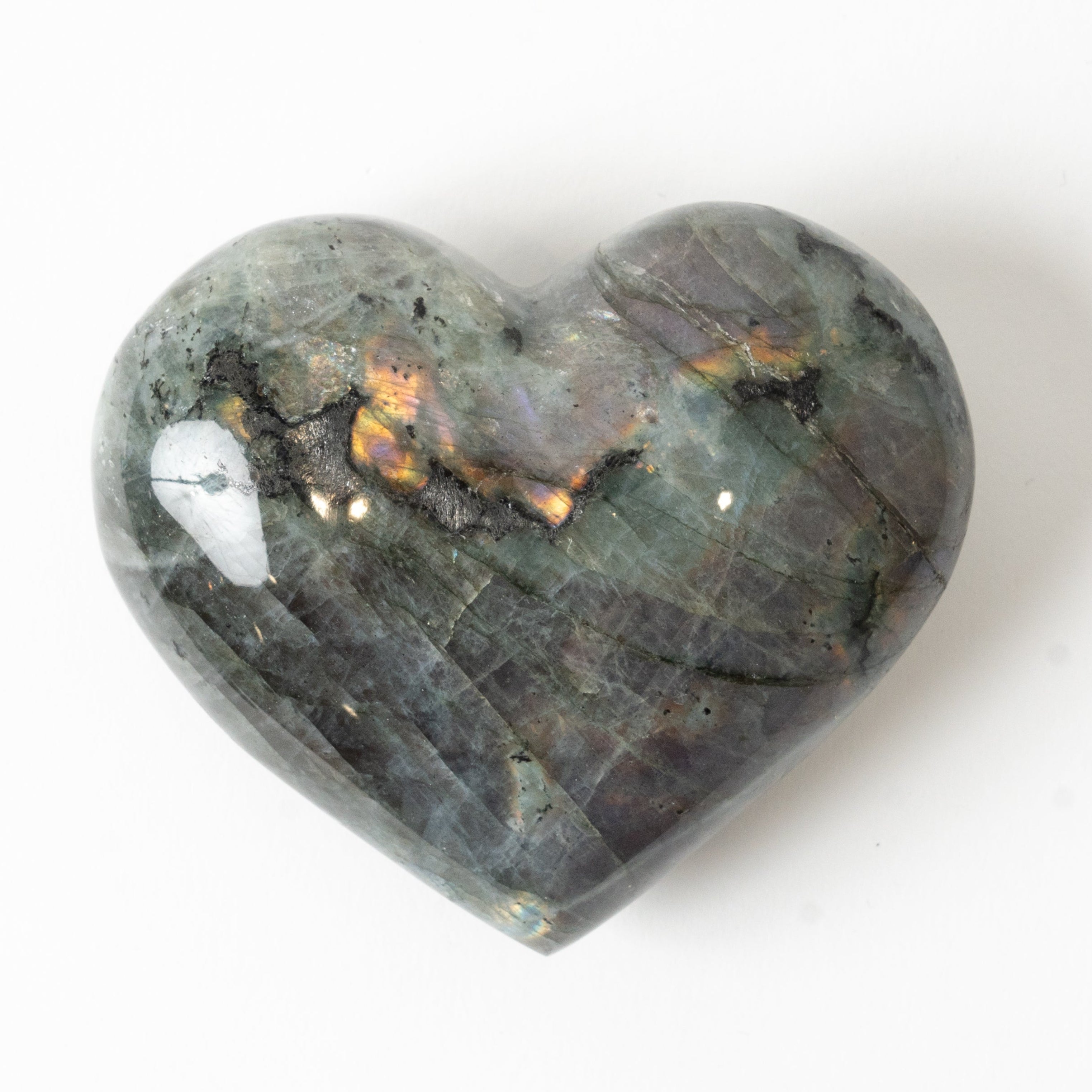 Heart-shaped labradorite stone on a white background