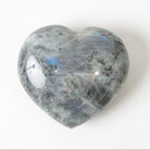 Heart-shaped labradorite stone on a white background