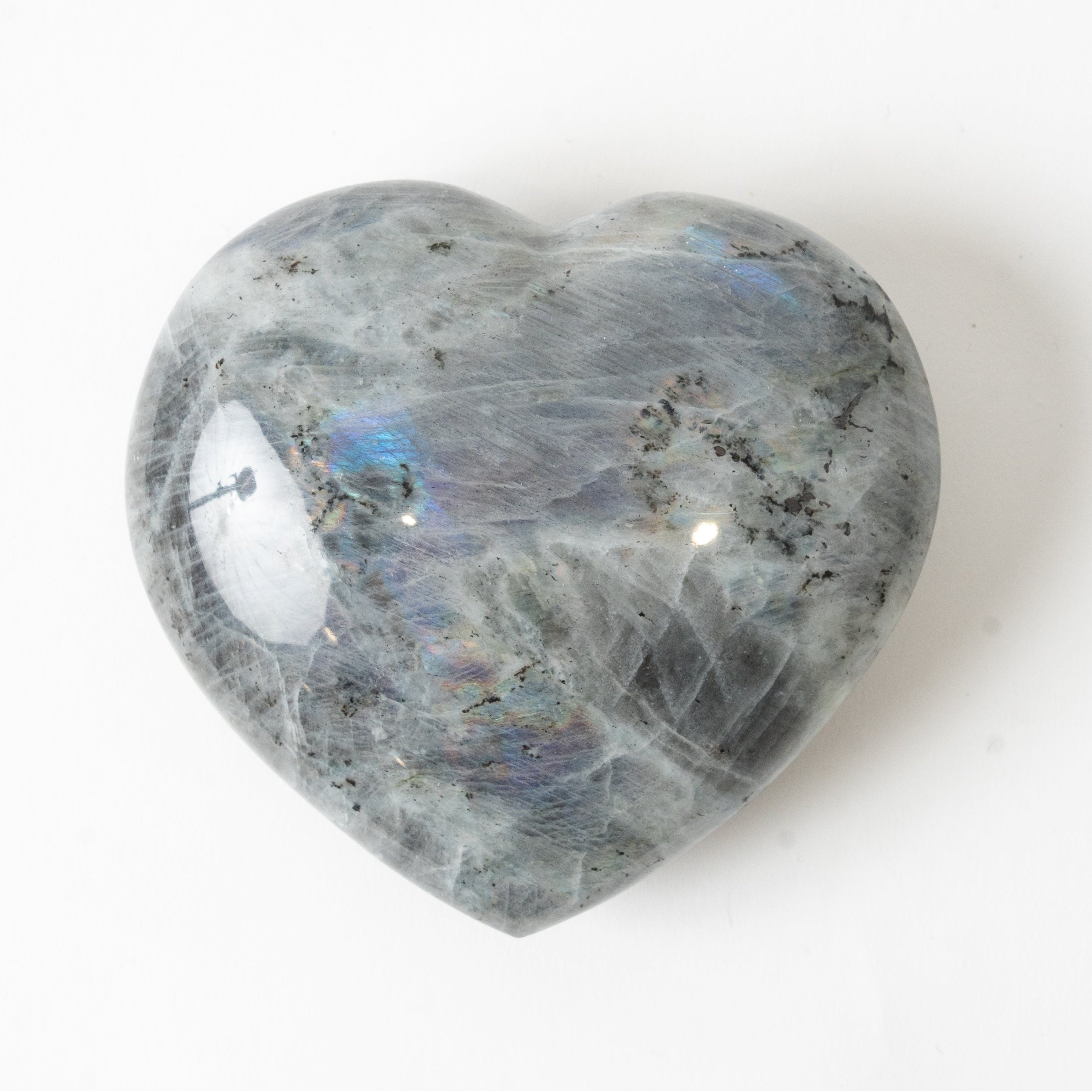Heart-shaped labradorite stone on a white background