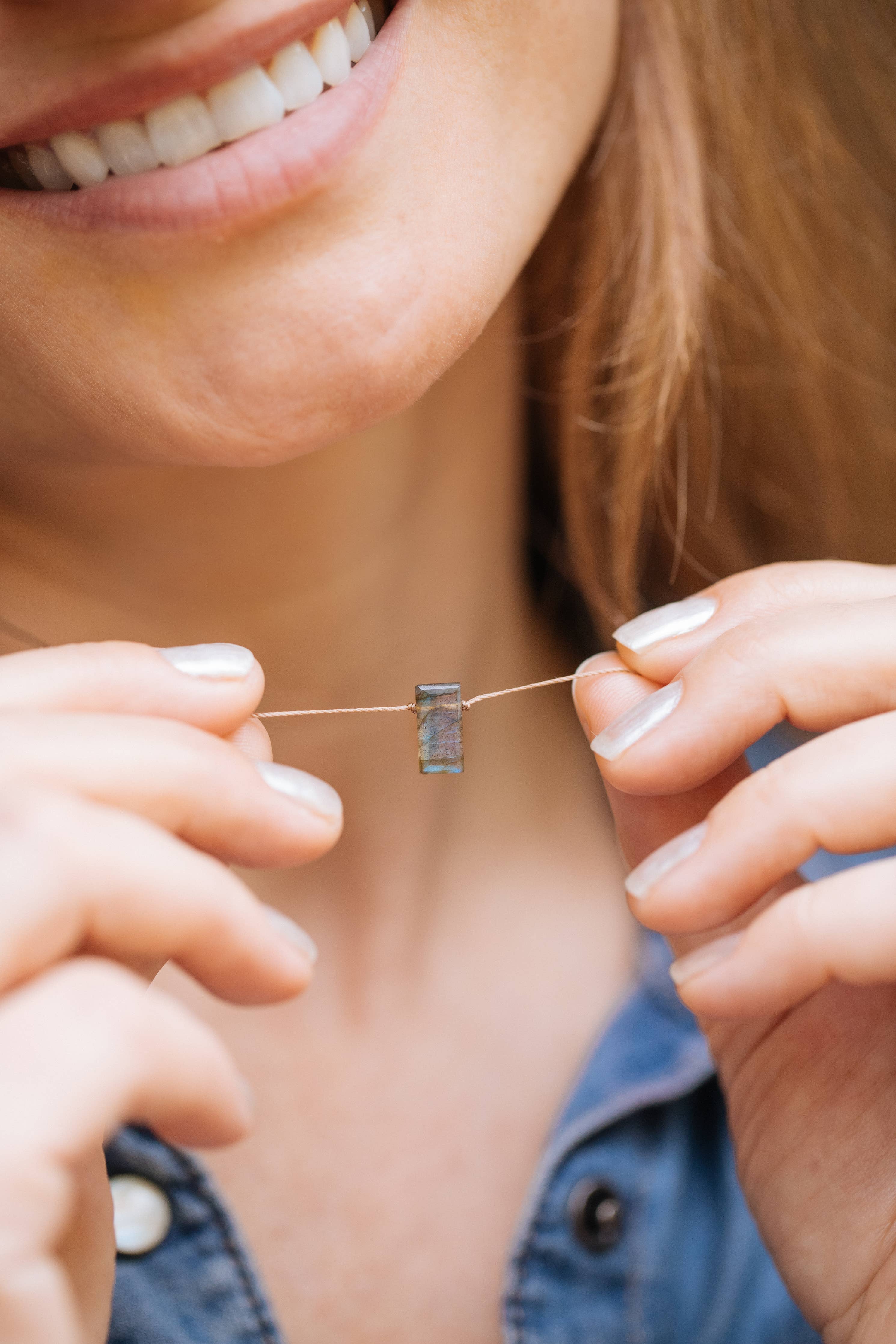 Labradorite Emerald Cut Necklace on Mighty Cord being Held by Hands