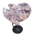 Pink Amethyst Geode crystal on a stand with a white background