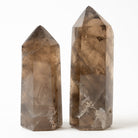 Two crystal Smoky Quartz  towers on a white background