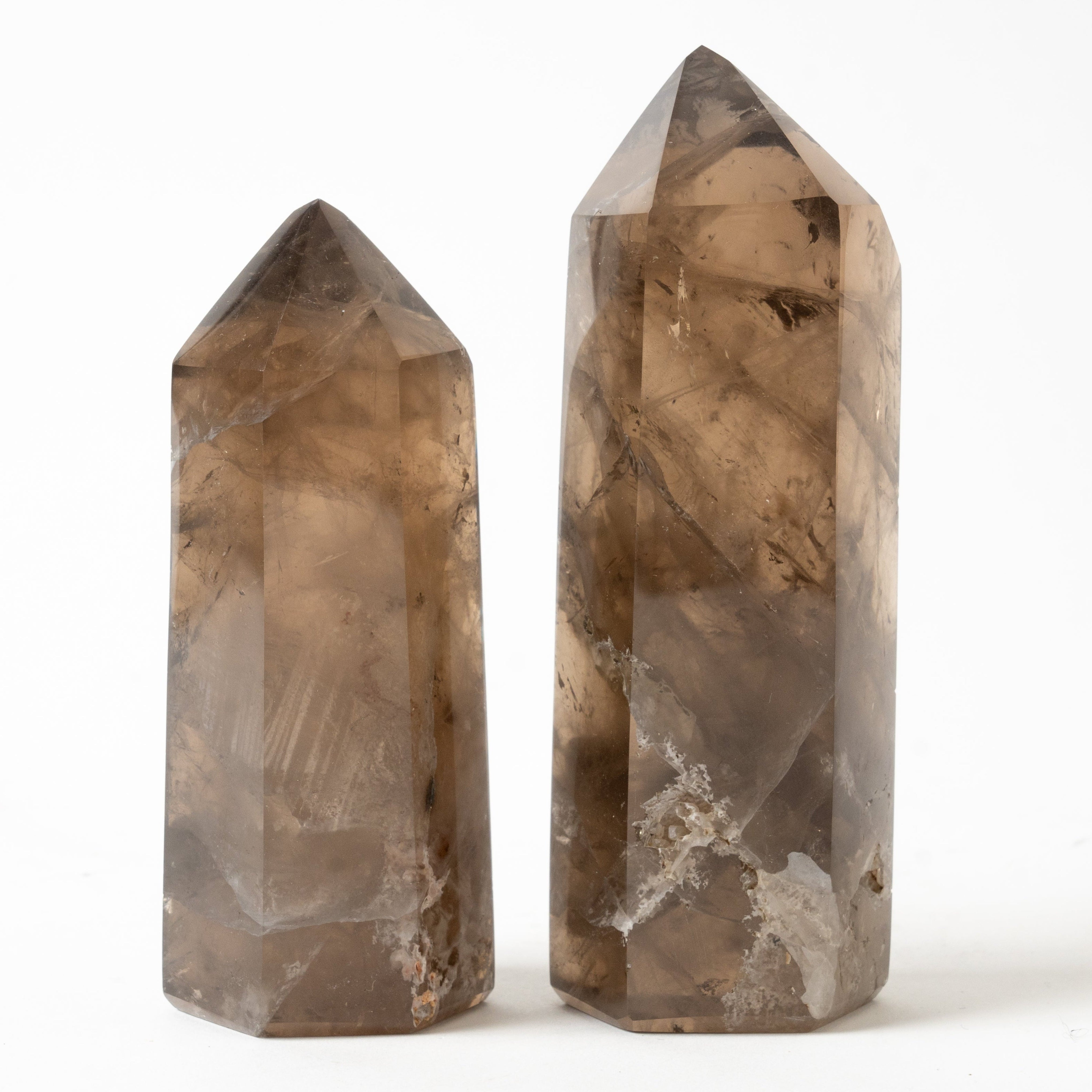 Two crystal Smoky Quartz  towers on a white background