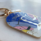 Keychain with Libra zodiac design on a marble surface