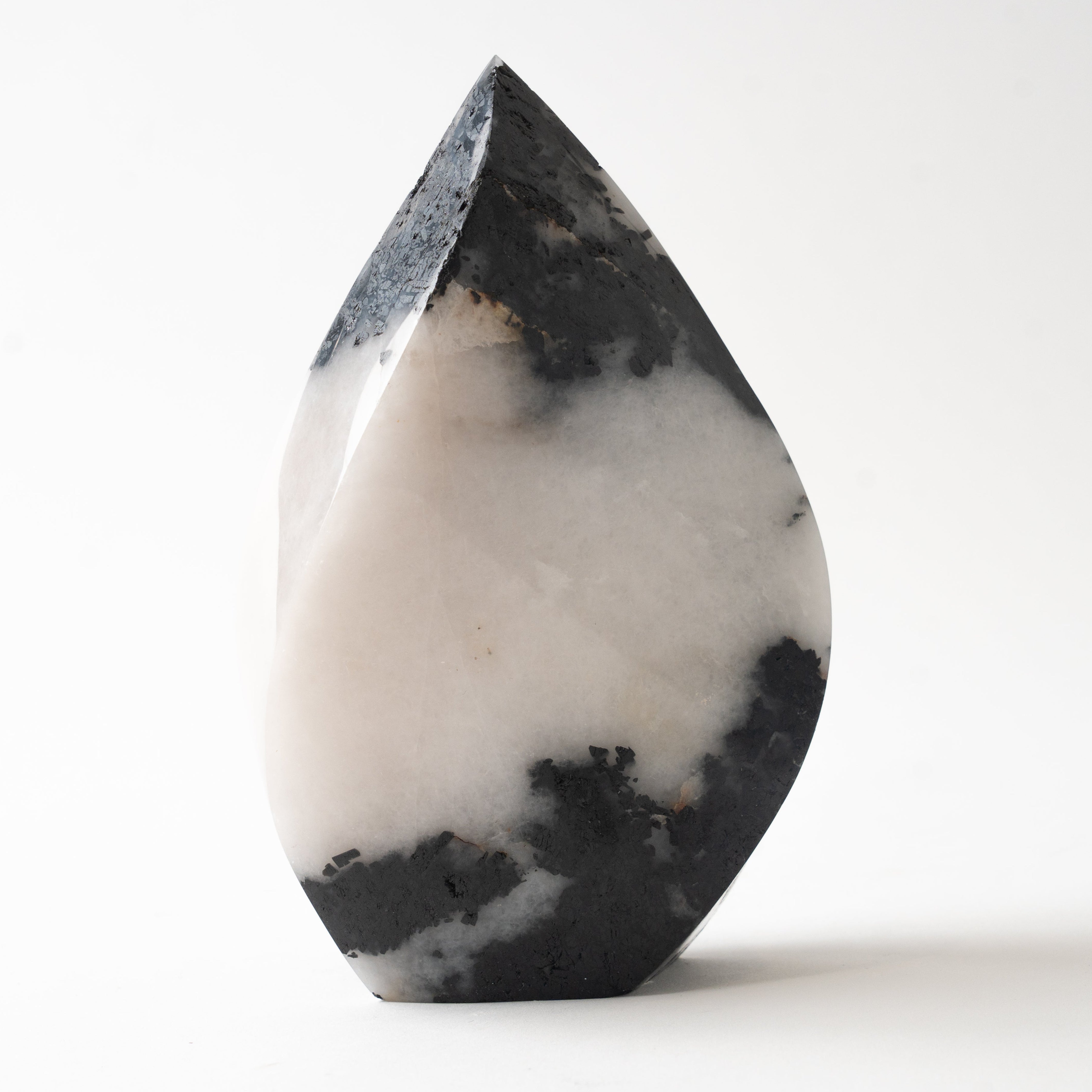 A polished teardrop-shaped natural stone crystal with a black tourmaline and white quartz, standing upright on a clean white background.